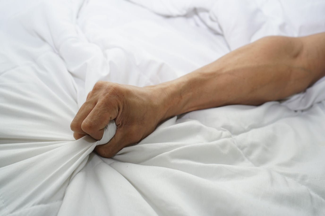 hand-of-men-pulling-white-sheets-in-ecstasy-orgasm.jpg