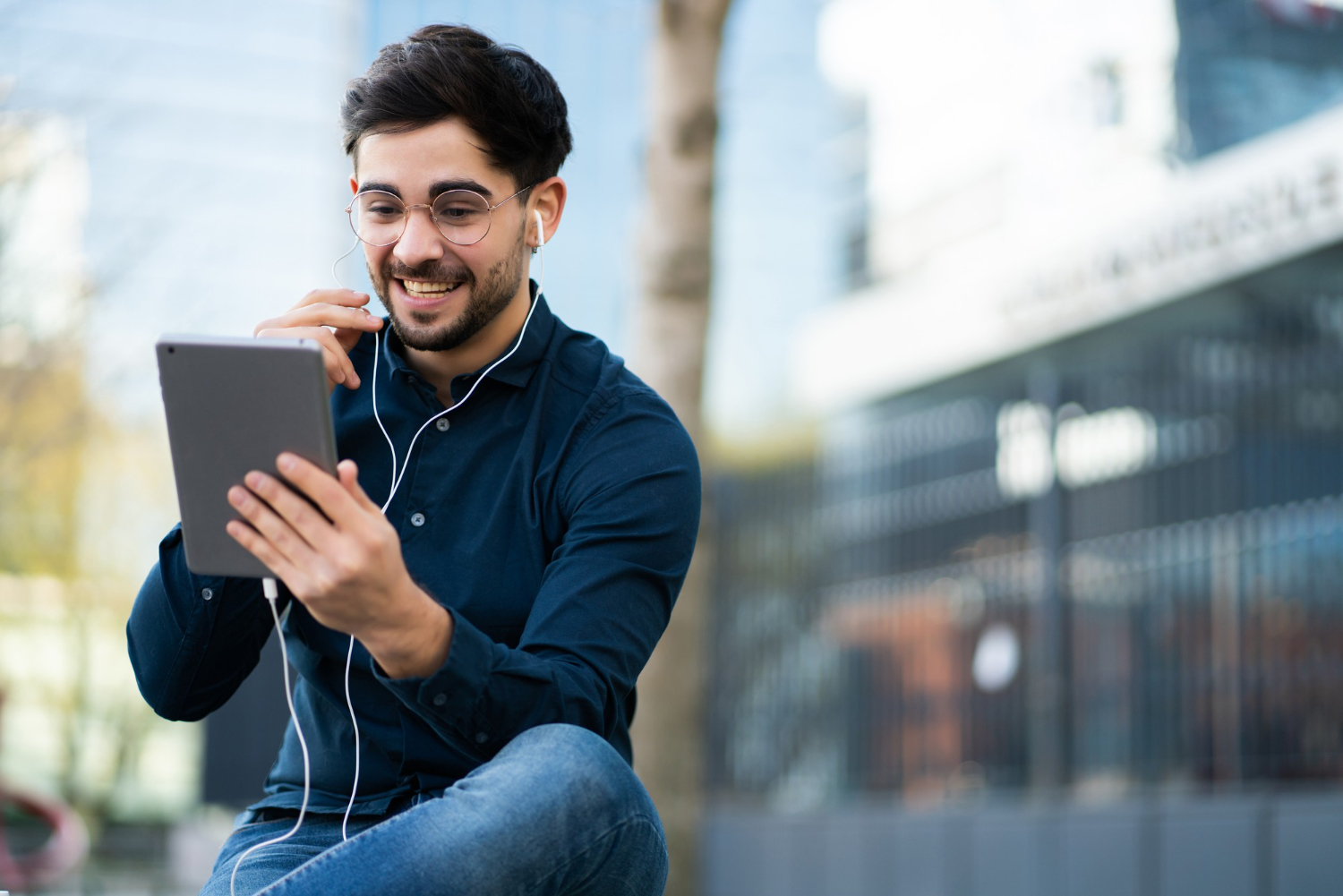 portrait-of-young-man-having-video-call-on-digital-tablet-while-standing-outdoors.jpg