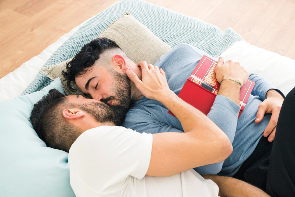 romantic-young-homosexual-couple-lying-on-bed-kissing.jpg