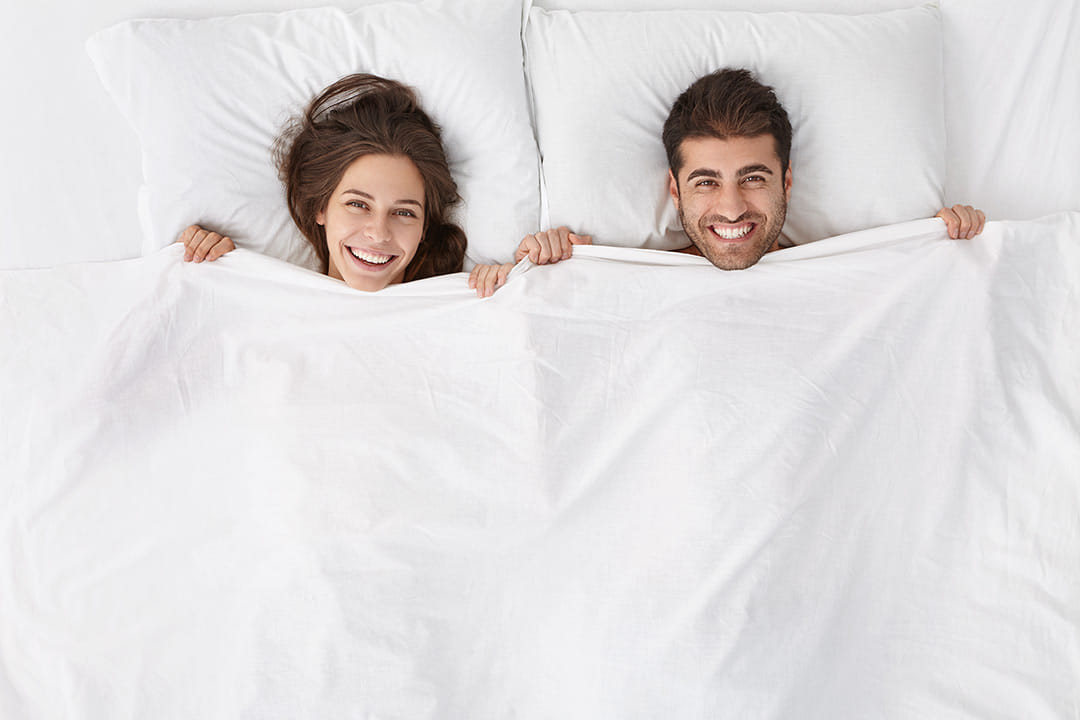 woman-and-man-sitting-in-bed-top-view.jpg